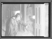 Worker looking in Machine