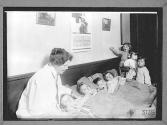 Woman with Group of Children resting Health Center