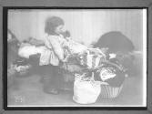 Child with Baskets of Clothing
