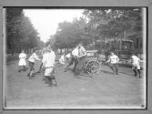 Children Playing in Playground Around Hurdy Gurdy