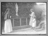 [Children Pray By Statue]