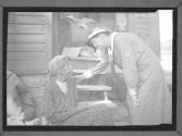 [ARC Woman with Flood Victim by Home]