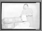 [Woman Sorting Clothes]