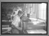 [Two Men with Hand Press]