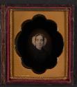 [Woman in a white headdress on a dark background]