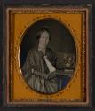 [Woman posing with her embroidery]