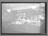 Delicatessen- Good Interior Scene With Detail Two Clerks