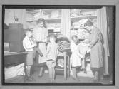 [Woman Dressing Children]