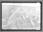 Group of Dock Workers Enjoying Smoke at Lunch Hour