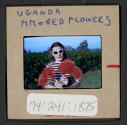 [Peggy Muray holding flowers, Uganda (travel slide)]