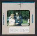 [Man and woman standing outside (travel slide)]