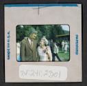 [Man and woman standing outside (travel slide)]
