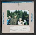 [Man and woman standing outside (travel slide)]