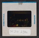 [People seated indoors (travel slide)]