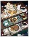 [Three dinner place settings (advertisement)]
