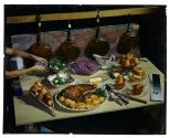 [Woman plating vegetables on buffet table (advertisement)]