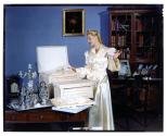 [Woman opening box (advertisement)]