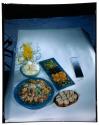 [Dishes of food on table (advertisement)]