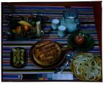 [Dishes of food on table (advertisement)]