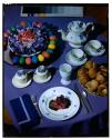 [Painted eggs, tea, and bread on table (advertisement)]