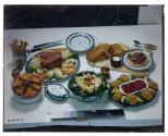 [Dishes of food on table (advertisement)]