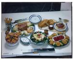 [Dishes of food on table (advertisement)]