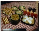 [Dishes of food on red checkered tablecloth (advertisement)]