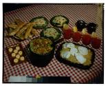 [Dishes of food on red checkered tablecloth (advertisement)]
