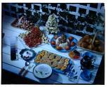 [Dishes of food on outdoor table (advertisement)]