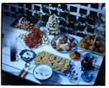 [Dishes of food on outdoor table (advertisement)]