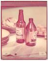[Beer bottles, cheese, and chips on table]