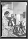 [Woman with Loom and Supervisor]