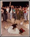 Dead Chinese-Beijing citizens yell oaths against the government as they gather around the body of a man who died when an armoured personnel carrier on its way to Tiananmen Square crashed through a which had been stopped by people Saturday night.