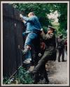 [Man attempts to scale the fence of the West German embassy]