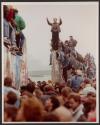 Berliners on top of the wall welcoming East Germans (back to camera) flooding through the wall into West Berlin at Potsdamer Platz passage which was opened by East Germany on Sunday morning.