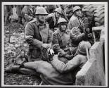 At Ease-Romanian soldiers guarding the national TV station, take a rest behind improvised barricades, Monday. The TV station was the scene of heavy fighting between army and Ceaucescu's Securitate.