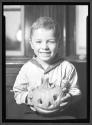 [Child Holding Pumpkin]