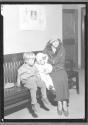 [Women and Two Children Waiting on Bench]