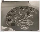 [Four place settings on table with dishes of food]