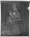 [Woman applying face cream at mirror (Jergens)]