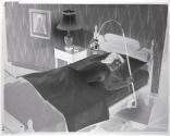 [Woman lying in bed under lamp]