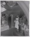 [Woman standing on staircase]