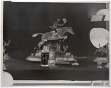 [Figurine of man riding horse and a bottle of whiskey (Hunter)]