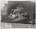 [Whiskey bottle and animal figurines including man riding horse (Hunter)]