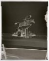 [Whiskey bottle, books, and a figurine of a man riding a horse (Hunter)]