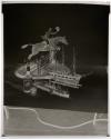 [Whiskey bottle, model ships, and a figurine of a man riding a horse (Hunter)]