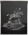 [Whiskey bottle and glass, model ship, and figurine of a man riding a horse (Hunter)]