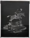 [Whiskey bottle and glass, model ship, and figurine of a man riding a horse (Hunter)]