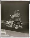 [Whiskey bottle and glass, figurine of a man riding a horse, fishing equipment, and Moby Dick book (Hunter)]