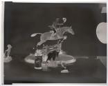 [Whiskey bottle, glass, and a figurine of a man riding a horse (Hunter)]